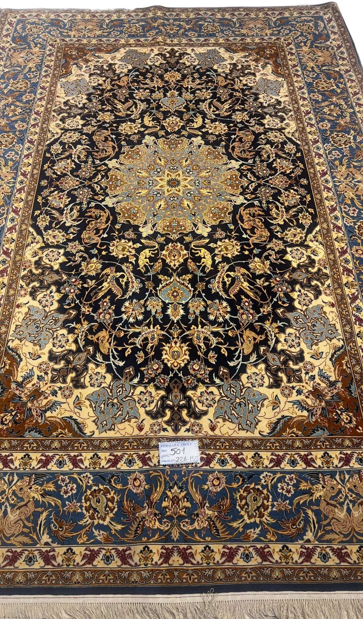 Hand-knotted Persian wool and silk rug from Isfahan, 60 years old and in excellent condition.